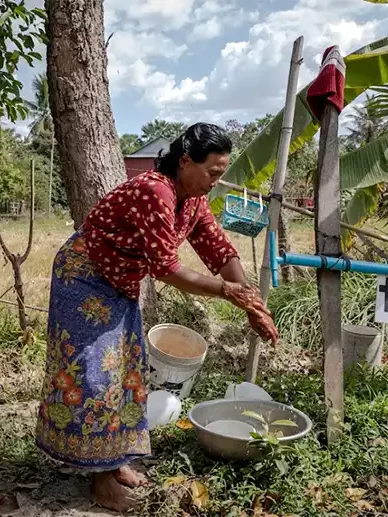 Impoverished woman washing hands